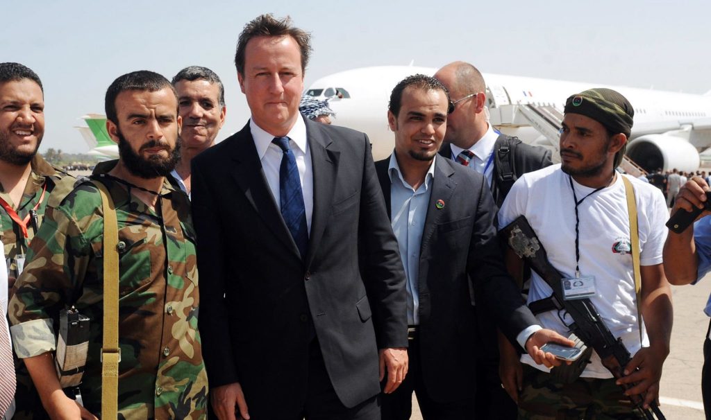 David Cameron walks with Libyan rebels upon his arrival at Benghazi Airport on 15 September 2011 (Photo: Stefan Rousseau / AFP via Getty)