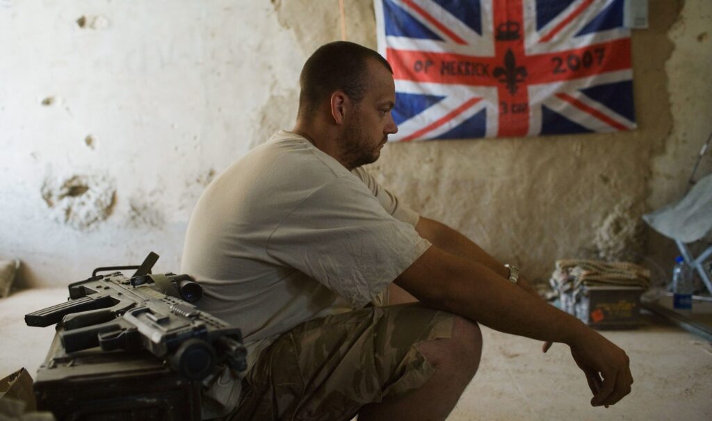 A British soldier rests at a base in Helmand, Afghanistan, 2007 (Photo: Marco Di Lauro / Getty)