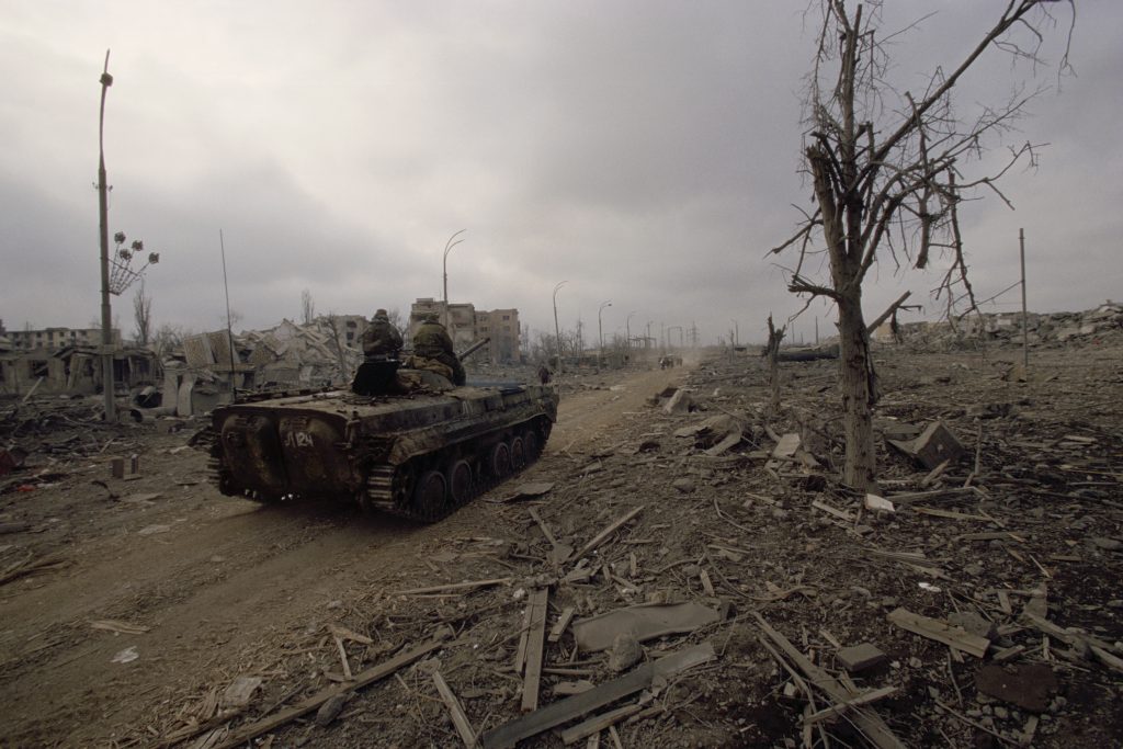 Russian soldiers roll through the bombed city of Grozny after intense fighting in the Second Chechen War, 15 February 2000. (Photo: Antoine Gyori/Sygma via Getty Images)